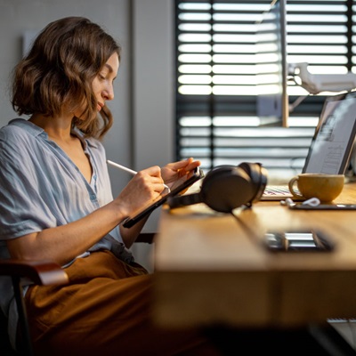 Woman taking notes on tablet device